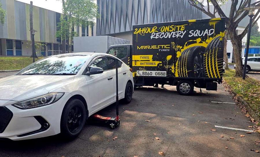 Mrrjestic Tyres technician performing an on-site tyre replacement next to a client's car